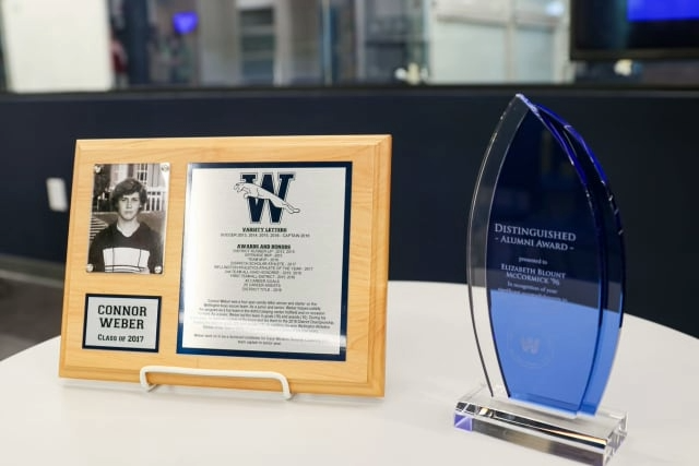 A plaque and award sitting on a white table